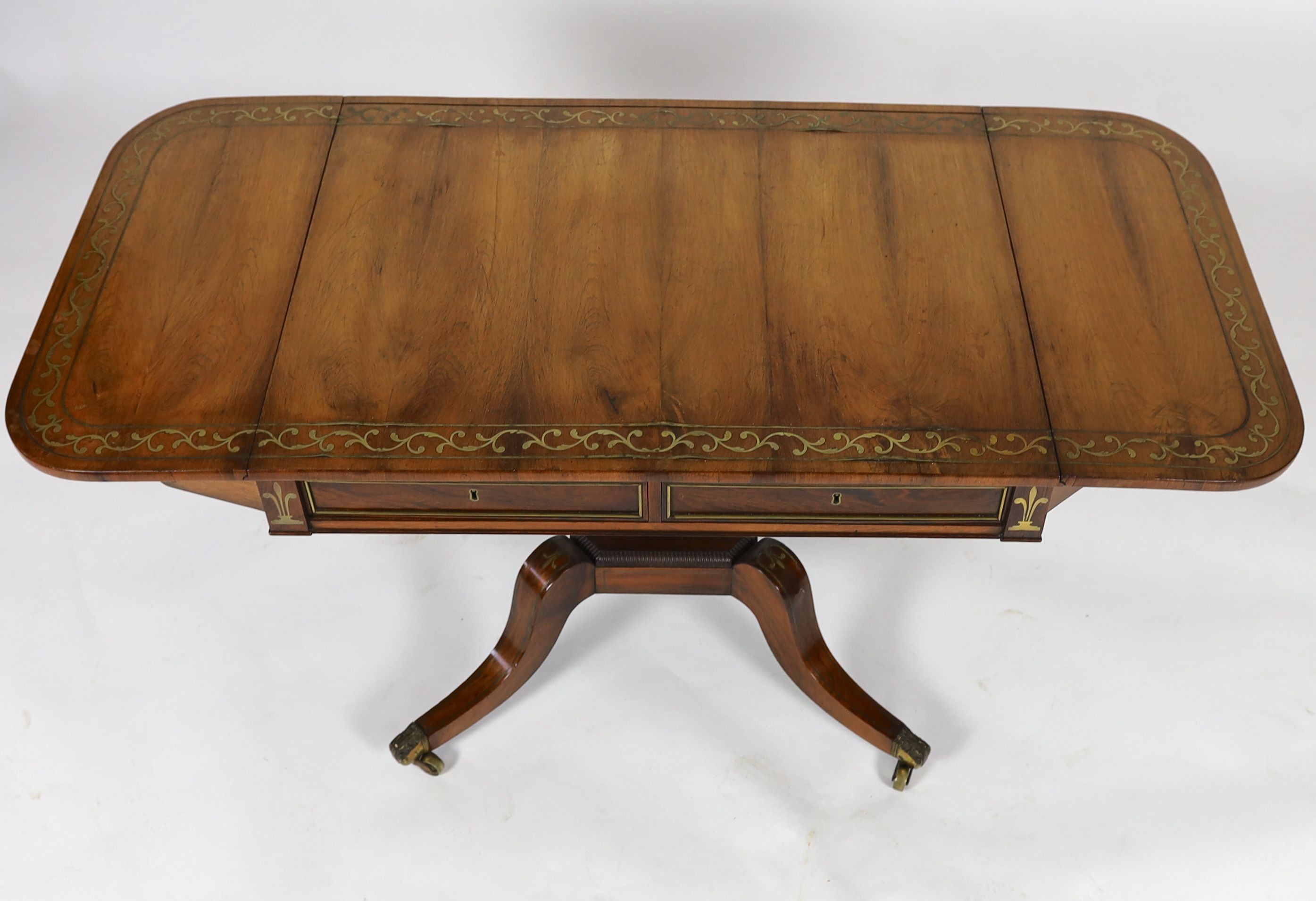 A Regency brass inset rosewood sofa table W. 94cm. D. 70cm. H. 72cm.